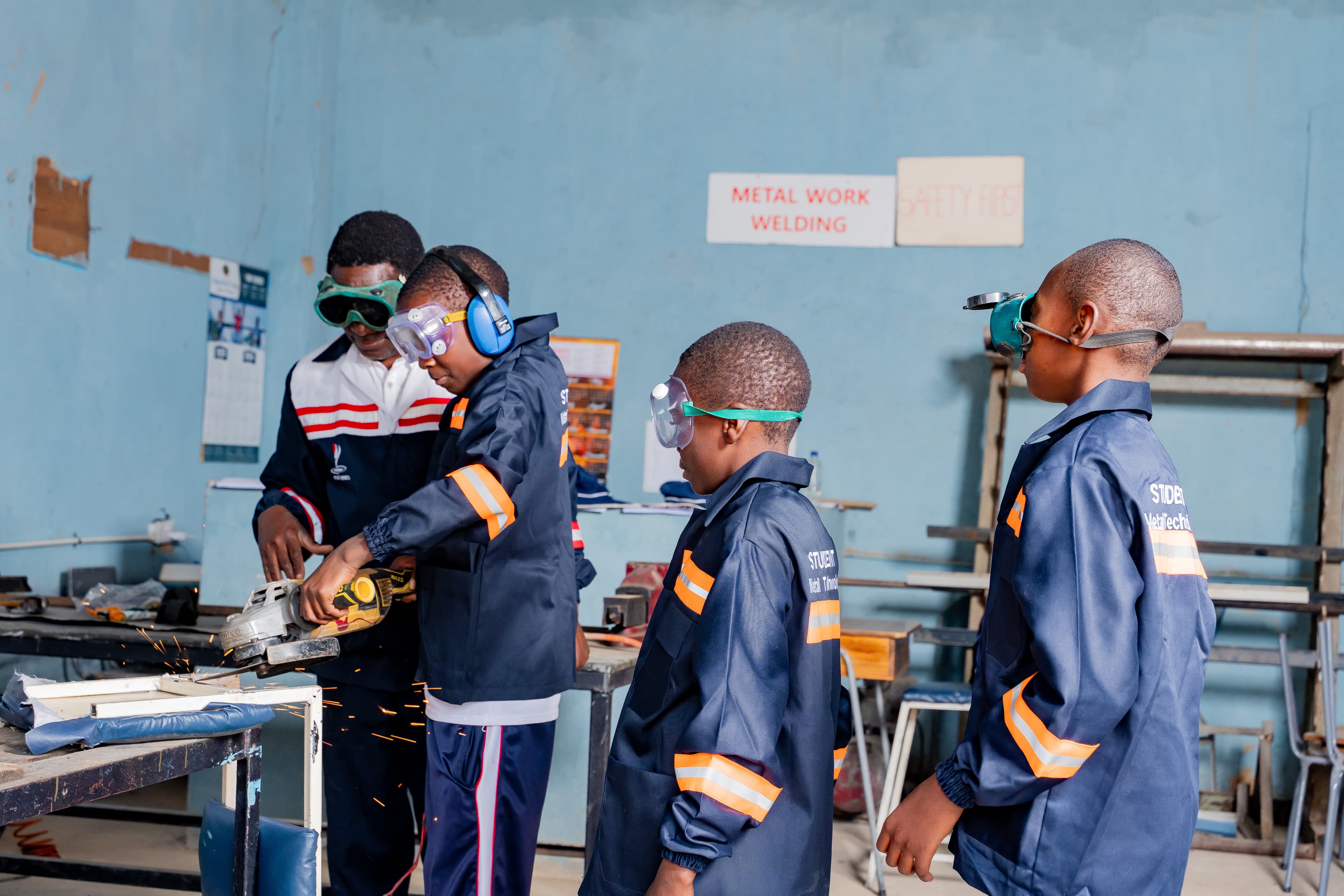 Students welding in the metal work workshop
