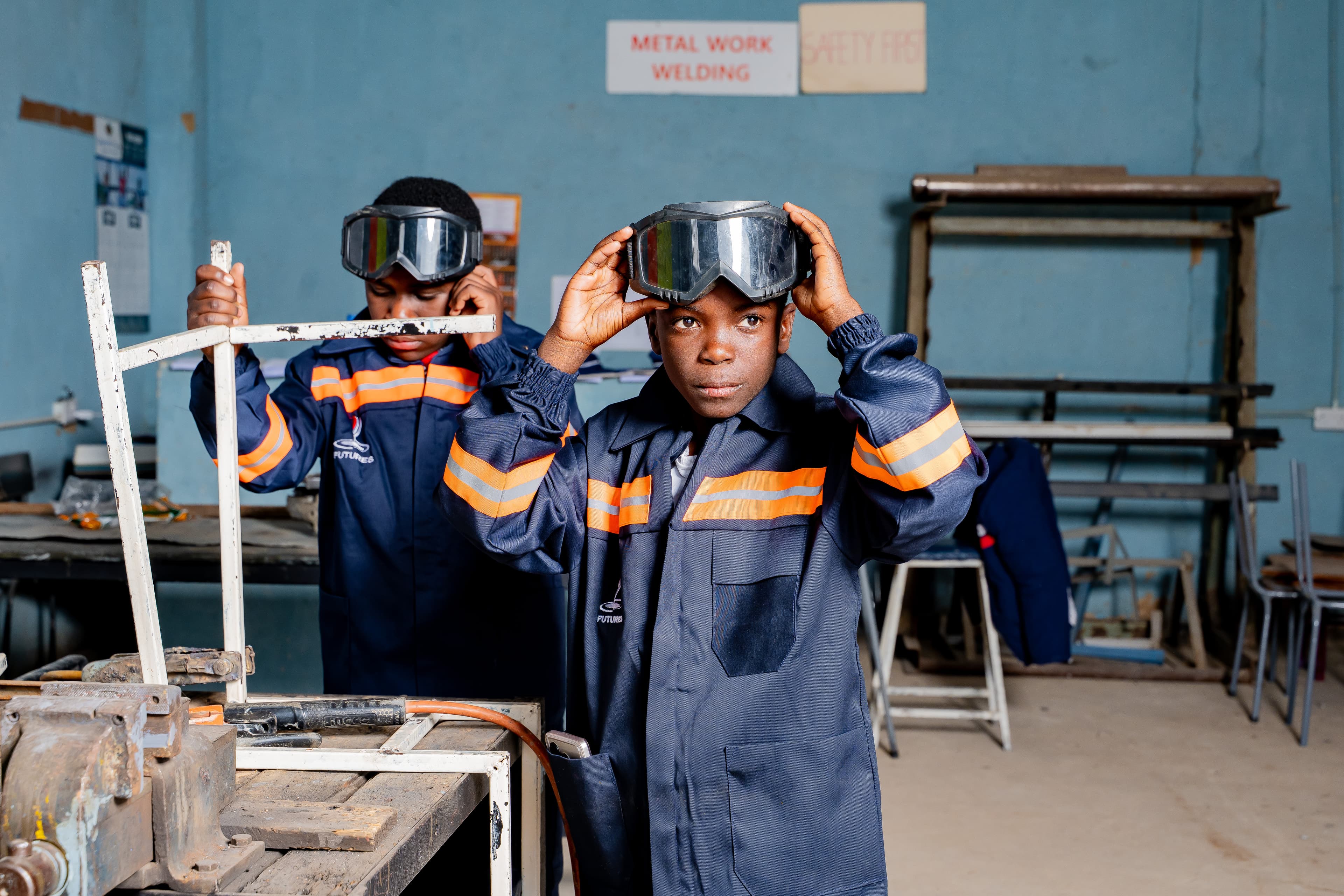Students welding in the metal work workshop