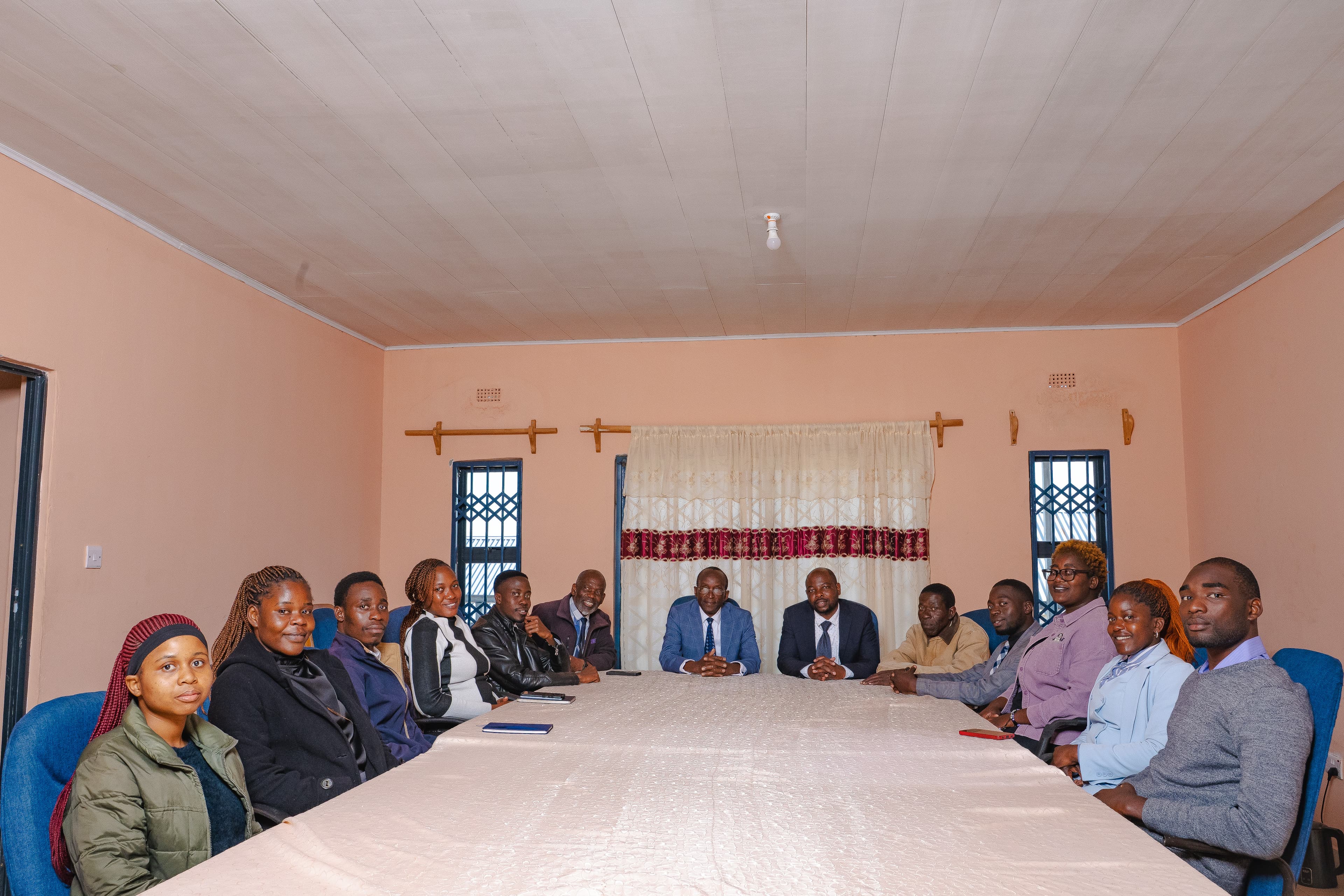 Staff Members siting in staff room for group photo