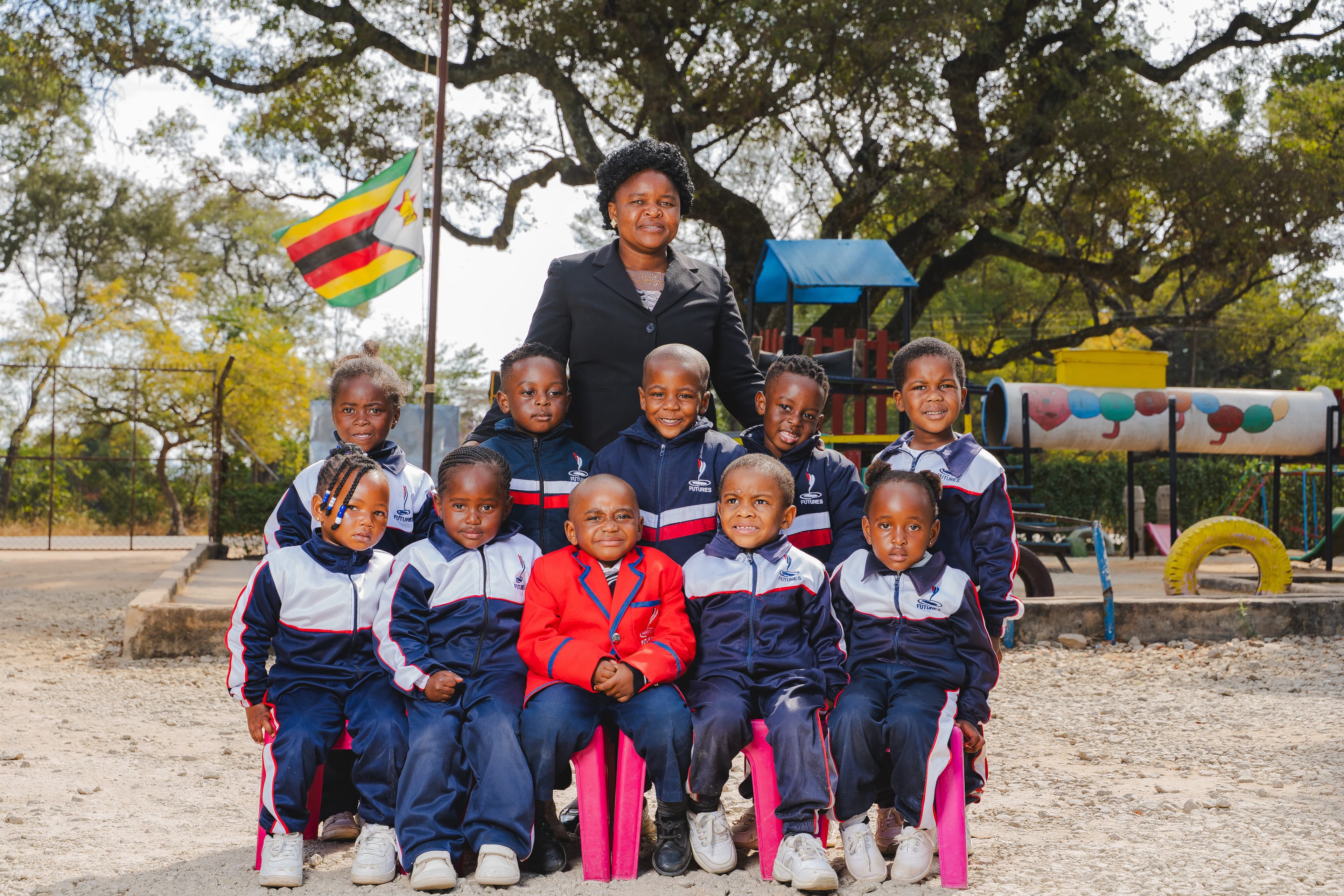 Teacher and clean students ECD siting professionally